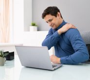 man sitting at desk with neck pain