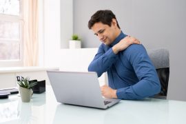 man sitting at desk with neck pain